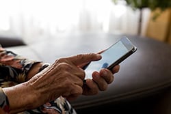 Smartphone-Compatible Hearing Aids - Woman's Hands Holding Smartphone